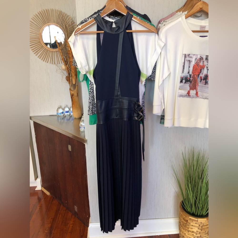 Navy blue dress with belt and pleated skirt.
